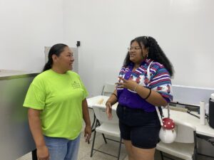 Two women stand in a cannery