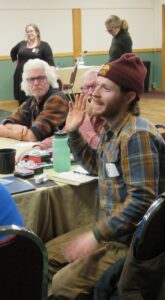 A conference participant has their hand raised.