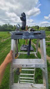 Photo showing tool setup for drilling holes in the cedar posts.