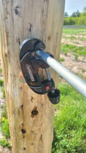 Photo showing EMT pipe cutter for insertion into drilled hole.