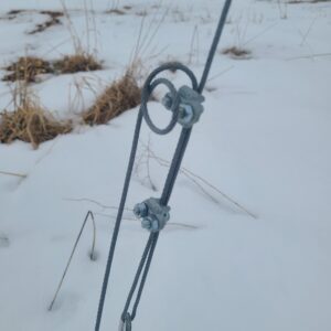 Photo of steel rope clips securing aircraft cable.