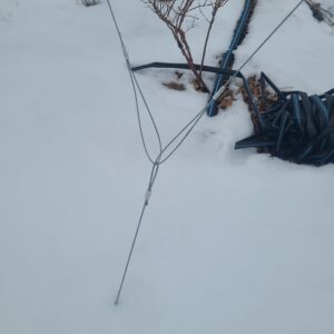 Crimped high tensile wire attached to an earth anchor for securing the t-posts.
