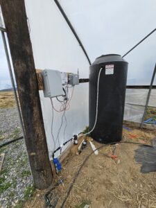 A 300 gal water tank and the Open_Irr irrigation control system inside a high-tunnel near Middleburg, PA.