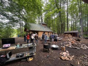 biochar demonstration with people and sugar shack in the background