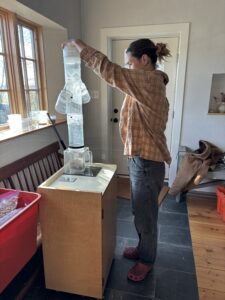 Person standing with plastic tube