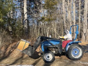 We used a bucket loader to load the queen bank hives into the overwintering unit.  Seen here.