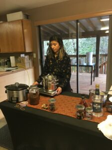 Local farmer and herbalist demonstrates tincturing methods at a workshop.