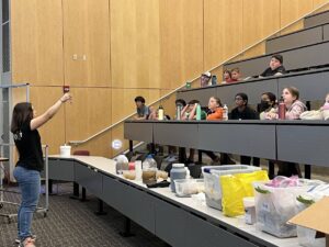 Showing a water sample to a class of 9-11 year old students