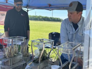 Local farmers, Adam Kolb and Nick Fitzgerald work to set up table top rainfall simulators.