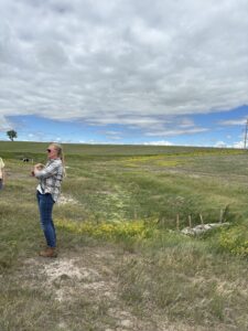 Woman talking in front of a wool dam