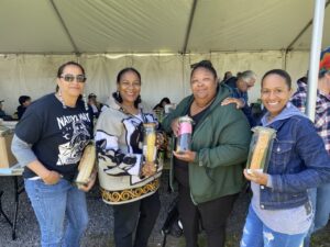 Shinnecock Nation delegation holding Indigenous corn seeds