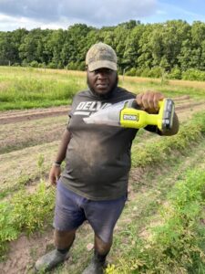 Farm Intern displaying a vacuum full of Colorado Potato Beetle larvae