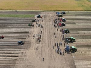 Field demonstrations during the afternoon of the MMWCFD. On the left (east) side of the field is vegetable weeding equipment. On the right (west) side is field crop weeding equipment. Case IH sponsored one tractor for use during the field day, fourth from the top on the right side of the image. Photo by Ashley Adair.