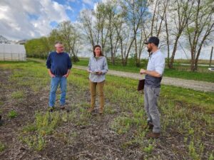 Jay Young (left, Throckmorton Purdue Ag Center), Chloe Henscheid (center, Meigs Horticulture Research Facility), and Sam Oschwald-Tilton (Glacial Drift Enterprises) discuss demonstration plot design in April 2024. Photo by Ashley Adair.