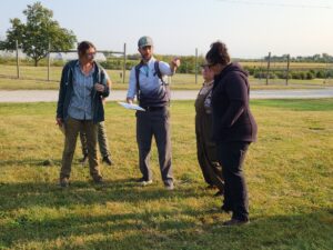Chloe Henscheid (left, Meigs), Jesse Schaffer (The Land Connection, obscured), Sam Oschwald-Tilton (Glacial Drift Enterprises), Crystal Siltman (The Land Connection) and Sarah Burton (The Land Connection) meet on September 10th for equipment load-in, trade show setup, and final plot preparations for the MMWCFD. Photo by Ashley Adair.