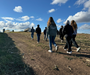 Students walk to visit a harvestable buffer strip during a conservation practice farm tour.