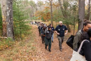 People walking down a trail in the woods
