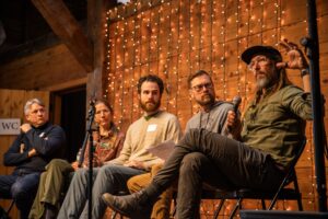 5 people on a stage in a panel discussion