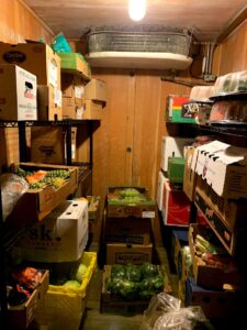 Photograph shows inside of a 1960s walk-in produce cooler.