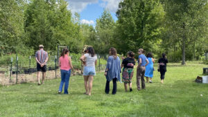Community members in garden learning during a tour