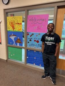 Te'Lario by signs made by students he's speaking to.