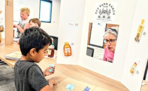 Shopping in the farmers market with monopoly money and real shopping bags.
