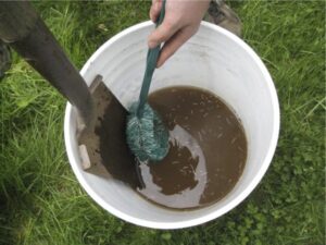 Sanitation bucket with filthy water, ready to be dumped