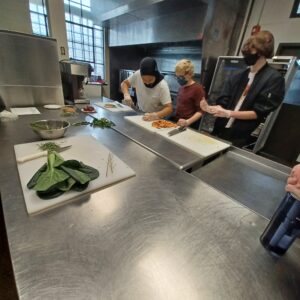 YSC members learning safe and effective knife skills in the kitchen