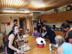 Group gathering for grinding masa and making tortillas. 