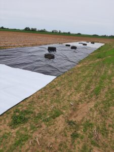 Tarps over field, with either white side up or black side up