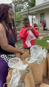 black mother and son garden produce