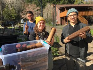 Making garden giant roll-ups with staff and a volunteer to grow in the medicine wheel