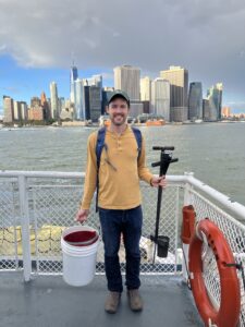 A man with soil sampling equipment standing on a ferry boat off Manhattan. Photo provided.
