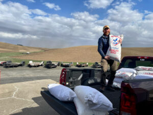 Dr. Kevin Murphy moving proso millet seed for the 2022 field trials. Photo by Tayler Reinman.