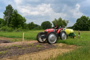 Figure 6: Eric Cornell of Yellowbud Farm fertilizes a field of chestnut nursery stock seedlings. 
