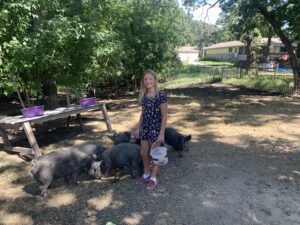 Gracie and Pigs - Farm Camp 2022