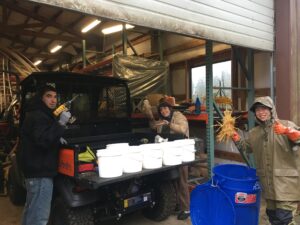Getting the first buckets inoculated with a staff member and a volunteer
