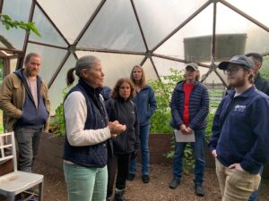 Farmers on a tour in OASIS in New Jersey.  Standing in a greenhouse dome