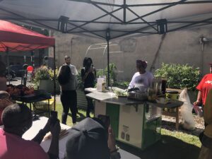 Farmer Participant Charlene Messer conducts a workshop on farm to table local entrepreneurship cooking with herbs and kale from her demonstration bed