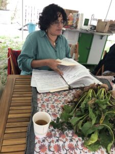 Roxana Marroquin at the workshop on Ecopreneurship /  herbalism with herbs from the demonstration beds.