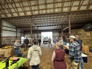 grower in barn explains strawberry production