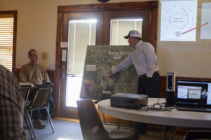 Dr. Stephenson discussing map of property with rancher. 