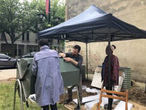 Co-PI and workshop faculty Emilio Panasci builds a compost bin with participants.