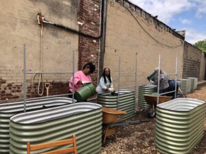 Farmer Participants add soil to their raised demonstration beds.