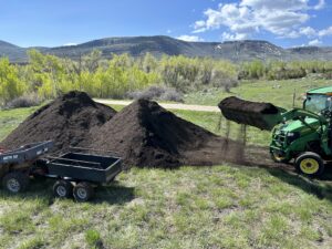 Tractor moving compost