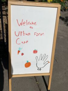 Welcome to Urban Farm Camp sign by intern Molly