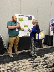 TPC staff speaking with landowner at the North American Prairie Conference in 2023