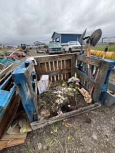 A pallet-constructed compost bin.