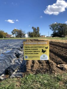 Sign at farm reads: COMING SOON: Black Butterfly Urban Farmer Academy Teaching Farm