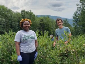 Sandra Nnadi with Ben Waterman at the Waterman Orchards during blueberry fruit harvest